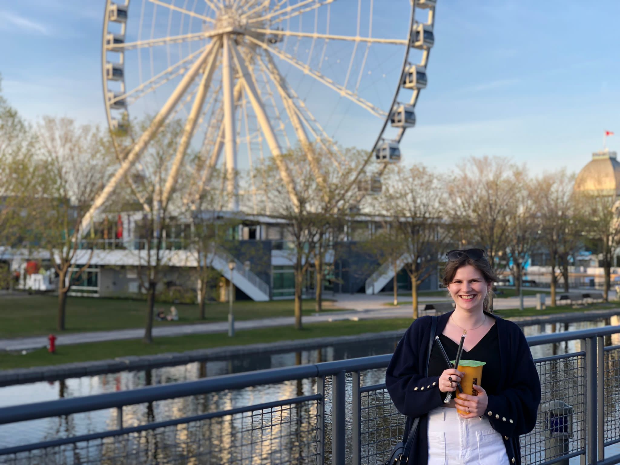 Picture of Marie standing in front of the Montreal Old-Port grande roue