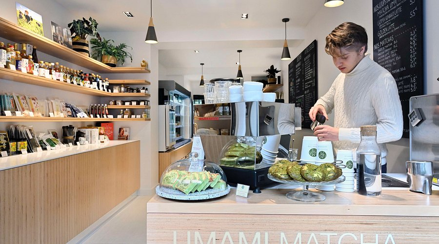 interior photo of a matcha cafe, cafe worker preparing a drink